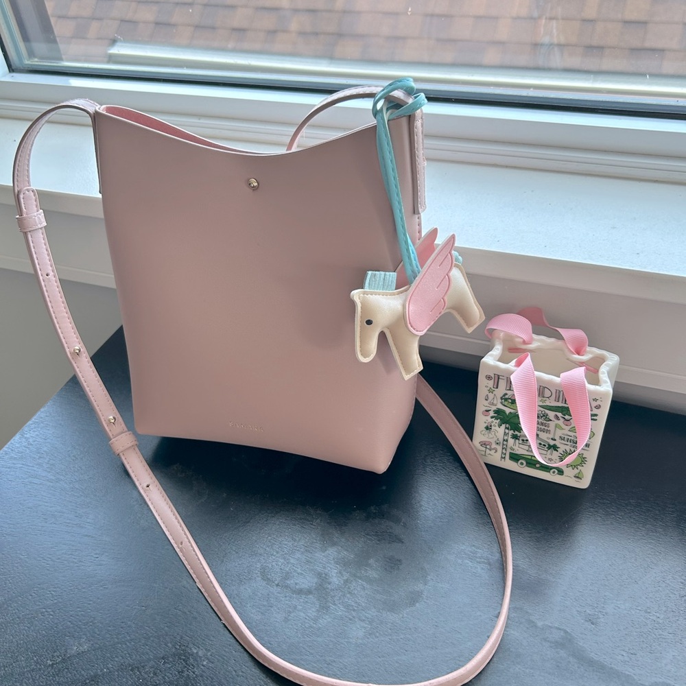 blush crossbody bag with Hermes’ charm